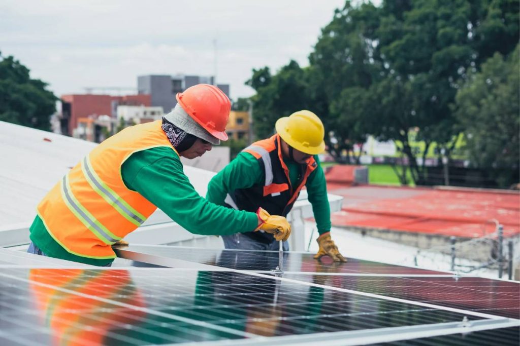 two south african solar panel installers attaching panels on roof